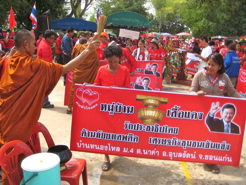 Villagers from Nong Lai Village recieve a blessing as they represent their community in processional that officially marked their village's opening as Red.