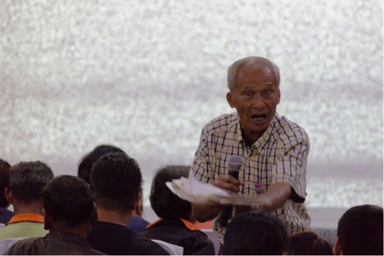 Not cowed by martial law: Villagers candidly speak out against human rights violations. In the background is the blurred screen of a censored video.